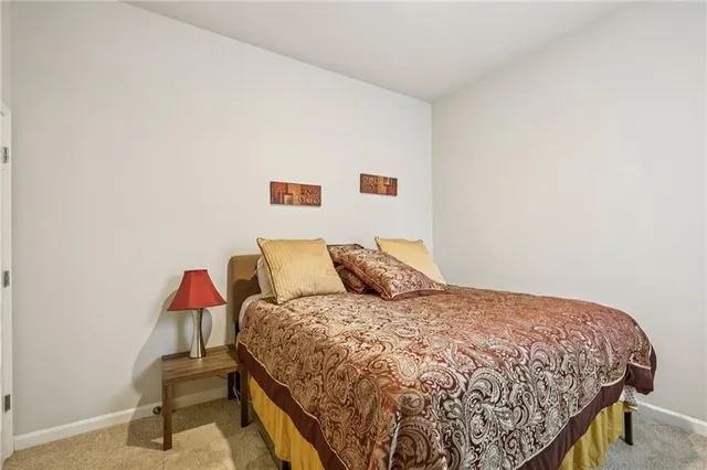 a large bed sitting in a bedroom next to a wall