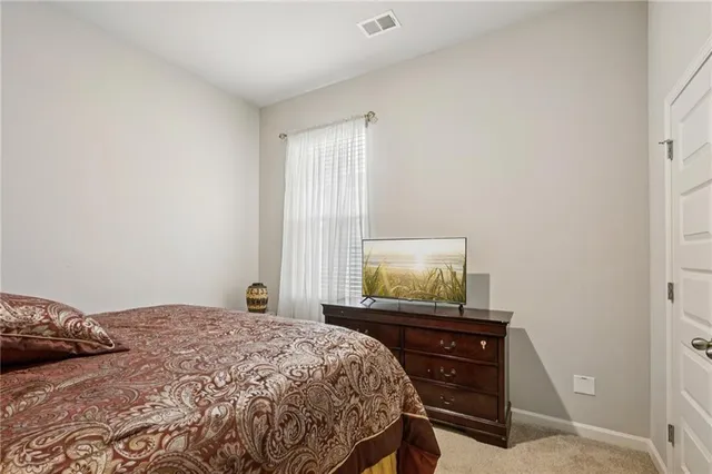 a bedroom with a bed and a dresser in it