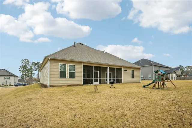 a view of a house with a backyard