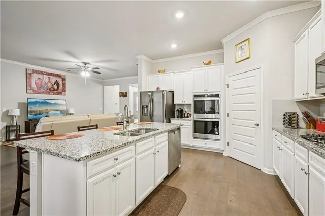 a kitchen with stainless steel appliances granite countertop a sink and cabinets