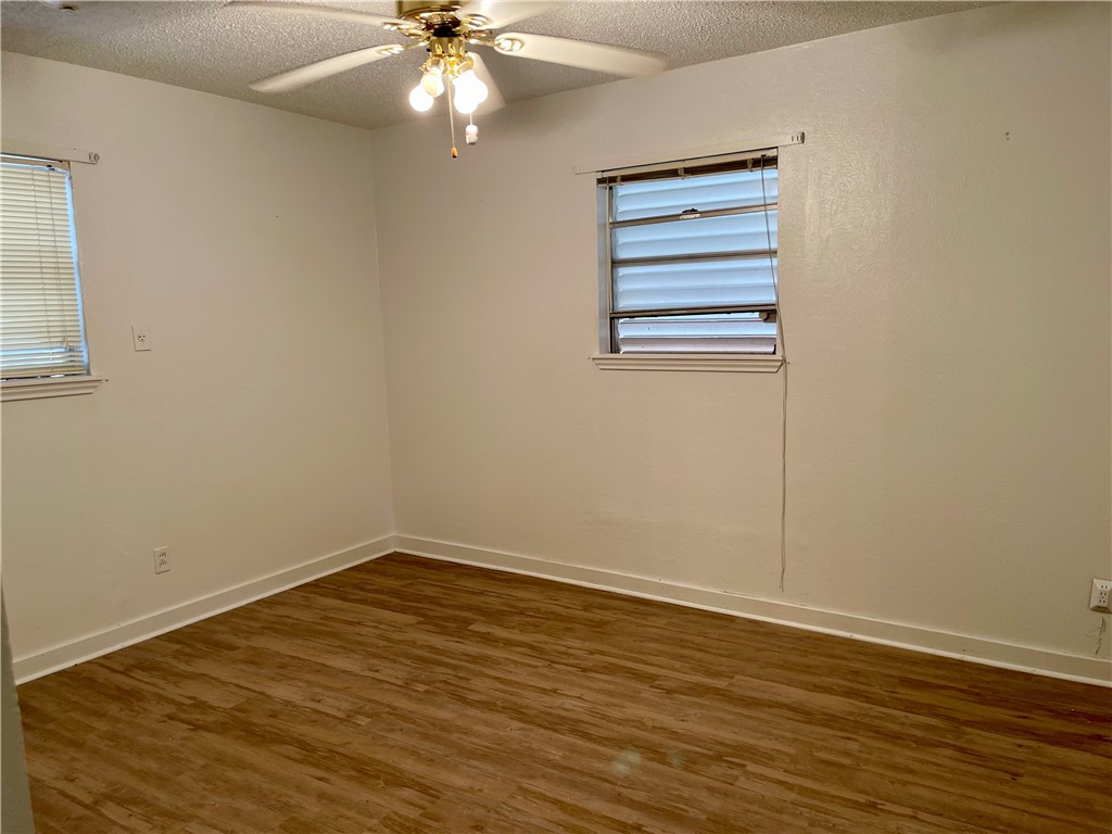 1101 Dewey Avenue Alice, TX 78332 - Photo 11 of 17 wooden floor in an empty room