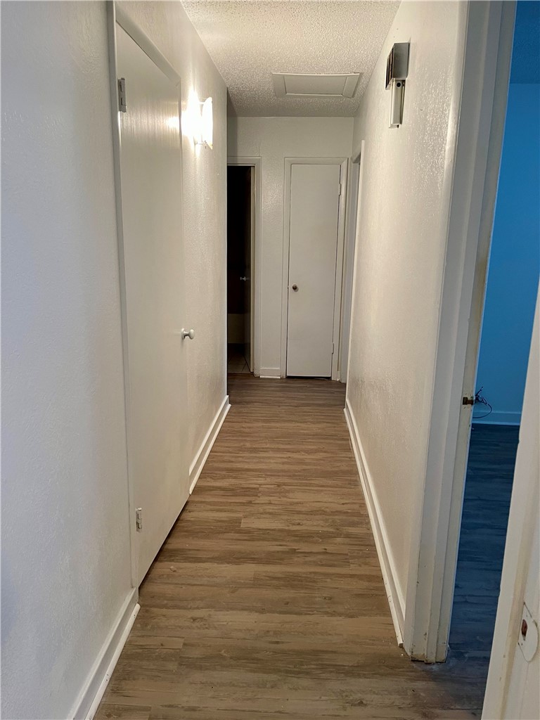 1101 Dewey Avenue Alice, TX 78332 - Photo 12 of 17 a view of a hallway with wooden floor and staircase