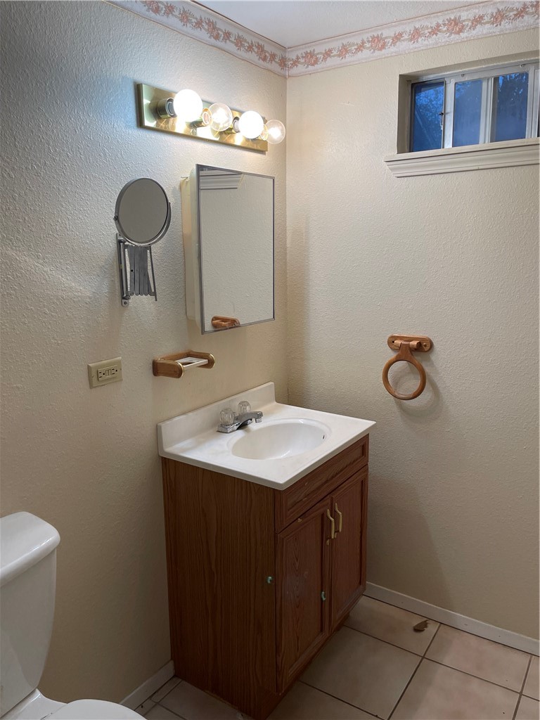 1101 Dewey Avenue Alice, TX 78332 - Photo 10 of 17 a bathroom with a sink and a toilet