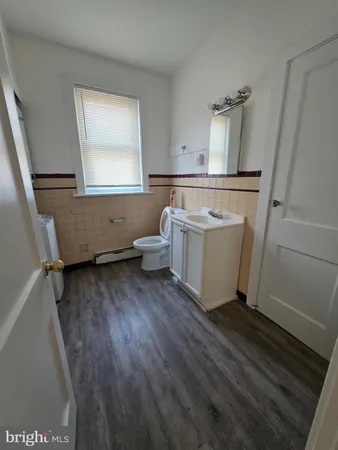 a bathroom with a bathtub a sink and a window