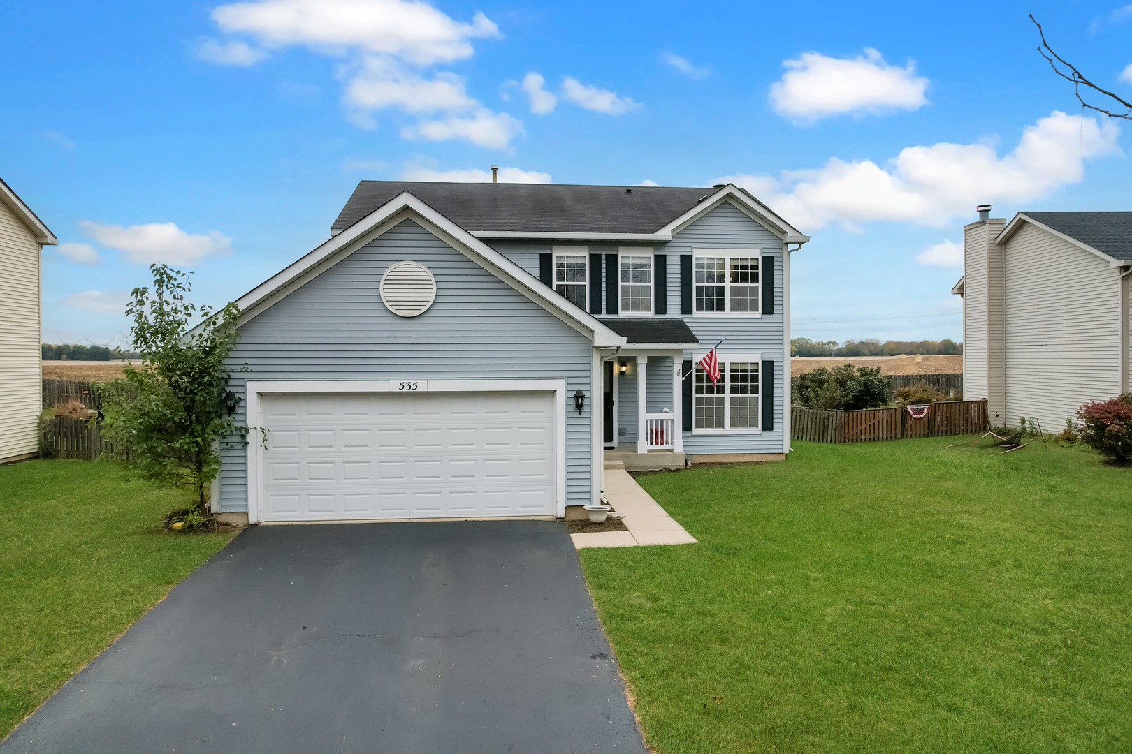 a front view of house with yard and green space