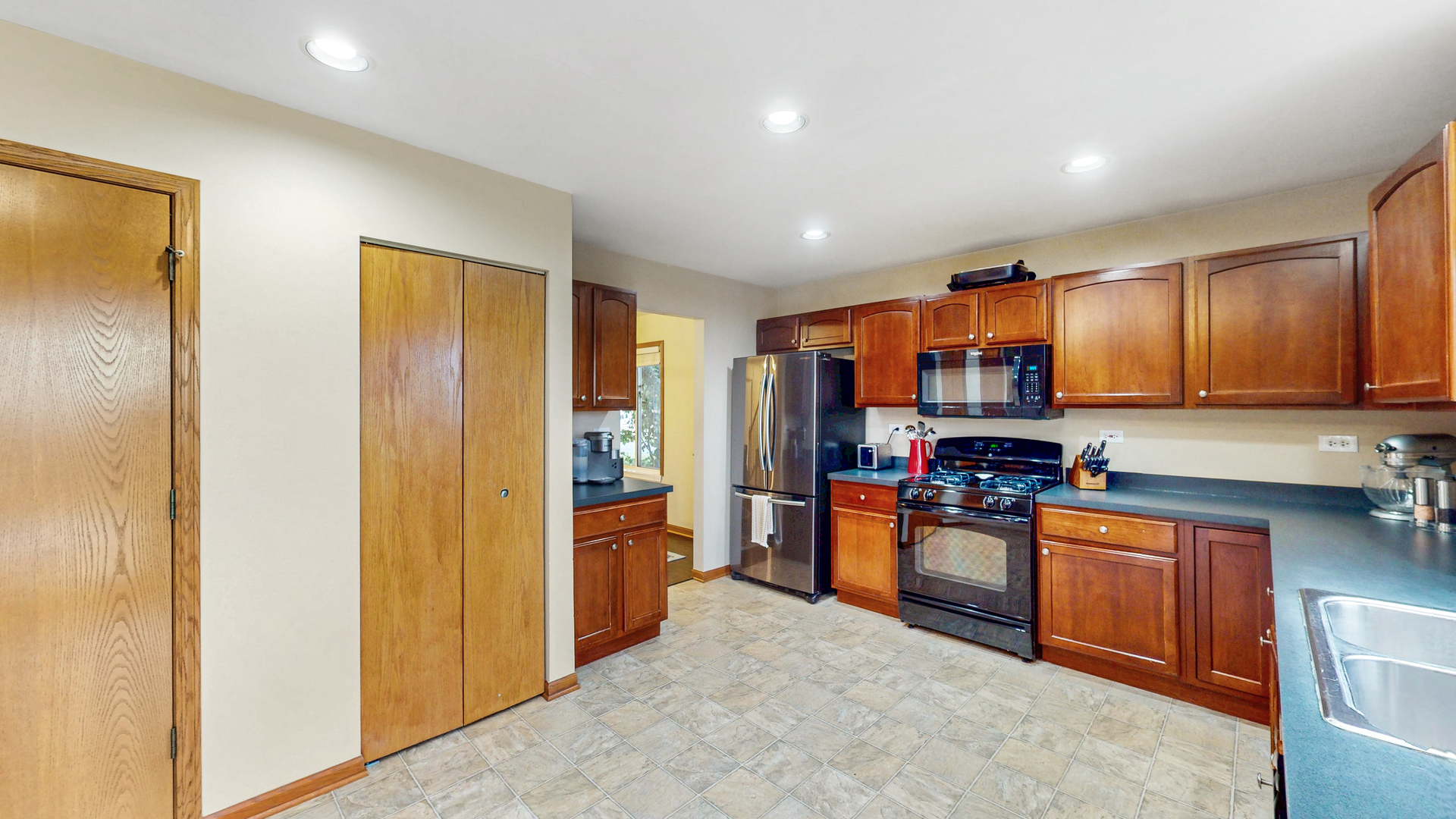 535 Alyssa Street Plano, IL 60545 - Photo 12 of 28 a kitchen with stainless steel appliances granite countertop a refrigerator and a stove top oven