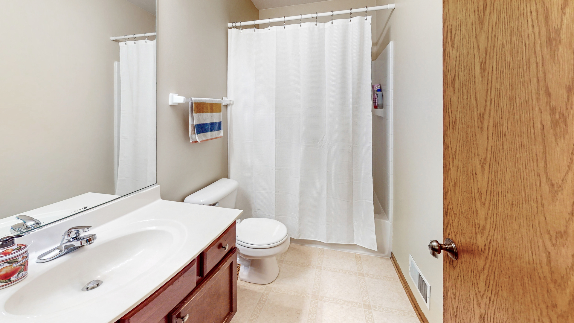 535 Alyssa Street Plano, IL 60545 - Photo 16 of 28 a bathroom with a sink a toilet and shower curtain