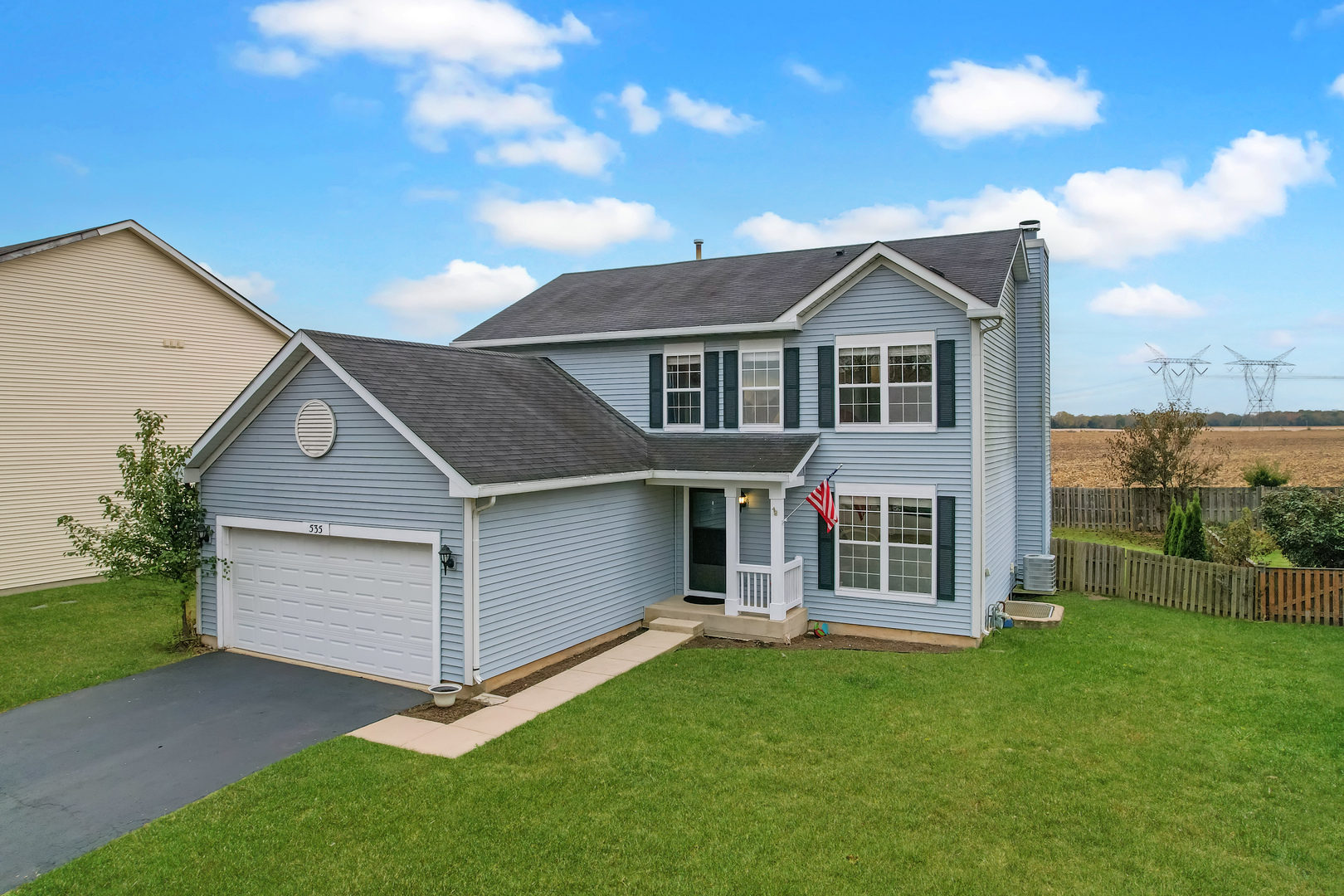535 Alyssa Street Plano, IL 60545 - Photo 2 of 28 a front view of a house with a garden
