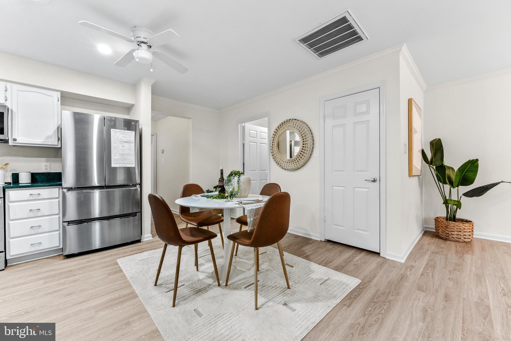 941 Riversedge Circle Annapolis, MD 21401 - Photo 14 of 48 a view of a kitchen with a dining table and chairs