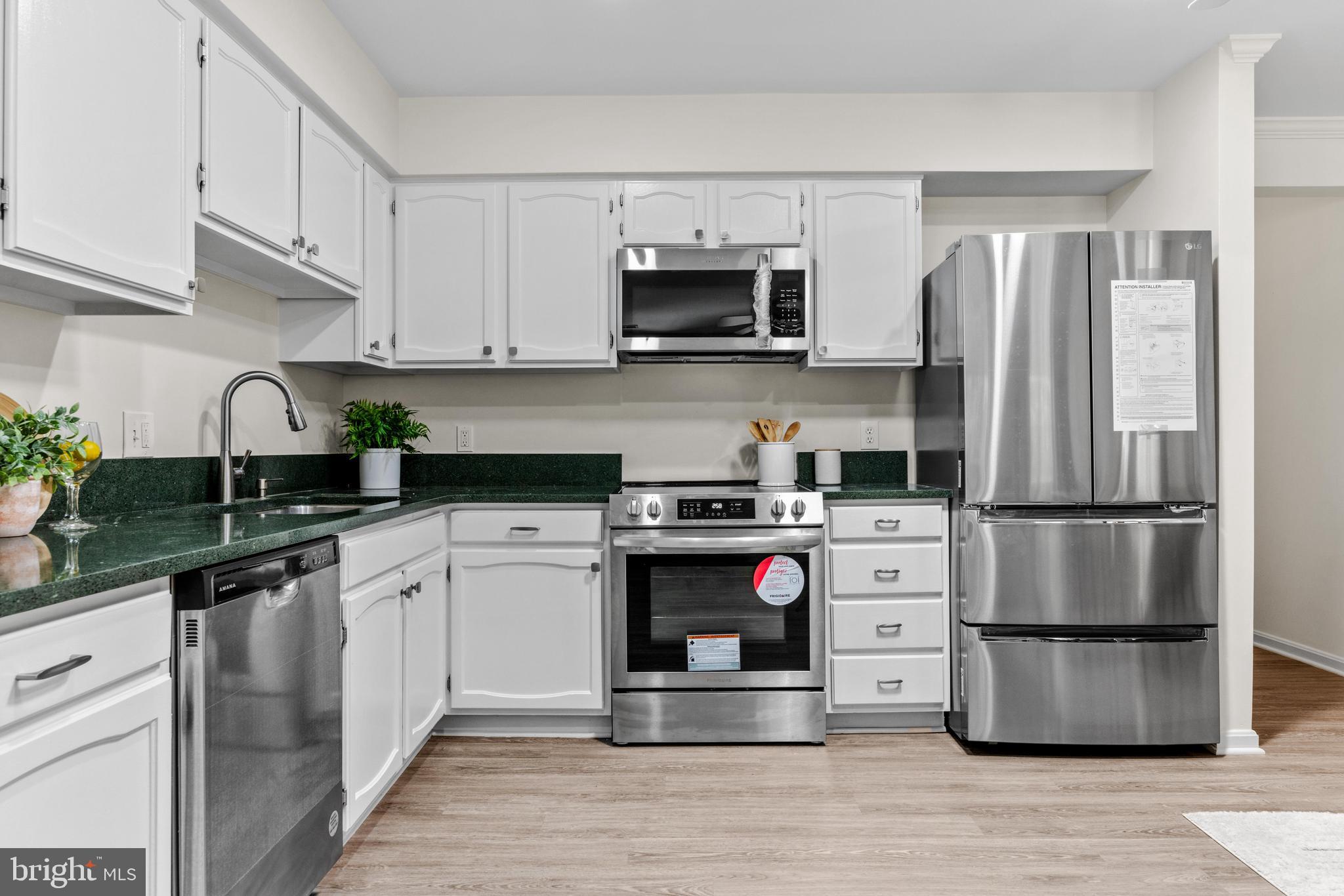 941 Riversedge Circle Annapolis, MD 21401 - Photo 15 of 48 a kitchen with stainless steel appliances a refrigerator stove microwave and sink