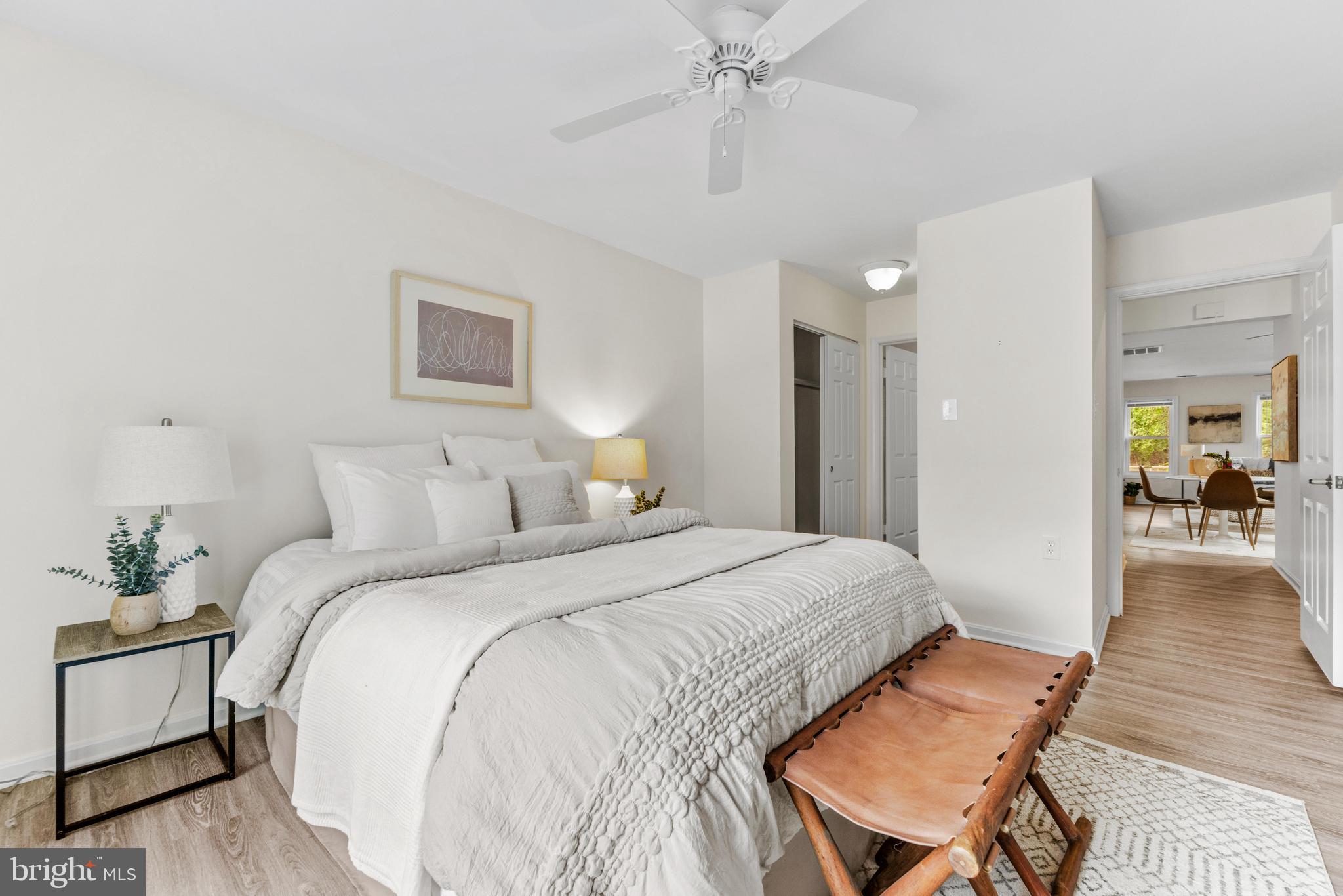 941 Riversedge Circle Annapolis, MD 21401 - Photo 23 of 48 a spacious bedroom with a bed and a chandelier