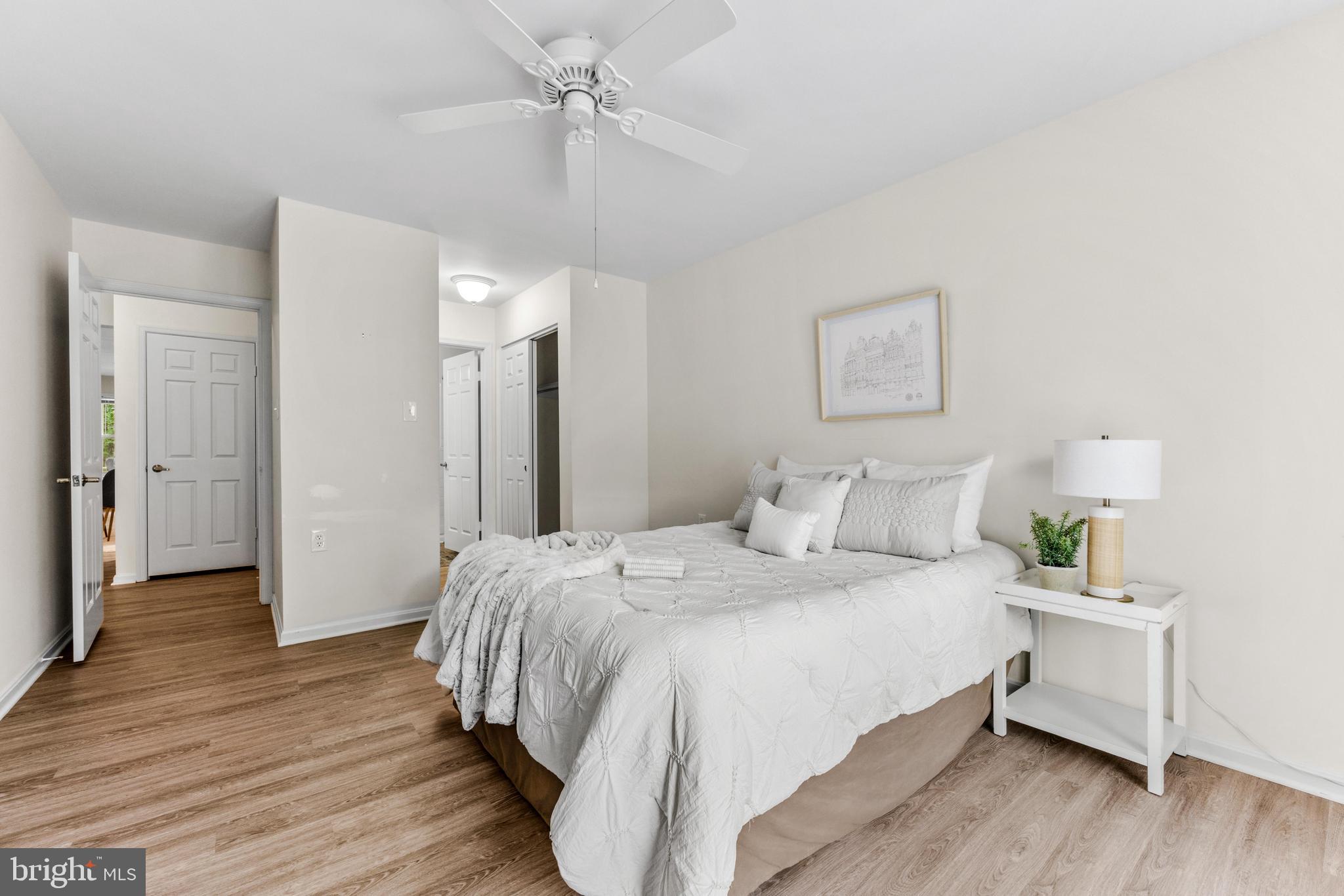 941 Riversedge Circle Annapolis, MD 21401 - Photo 26 of 48 a bedroom with a bed and a chandelier