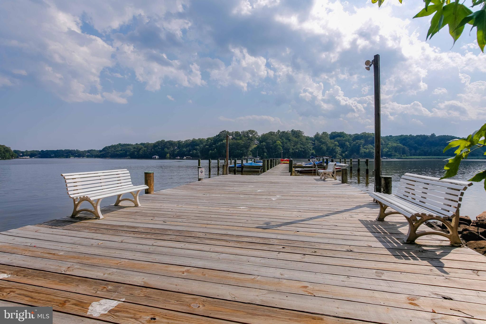 941 Riversedge Circle Annapolis, MD 21401 - Photo 37 of 48 a lake view with a bench next to a lake