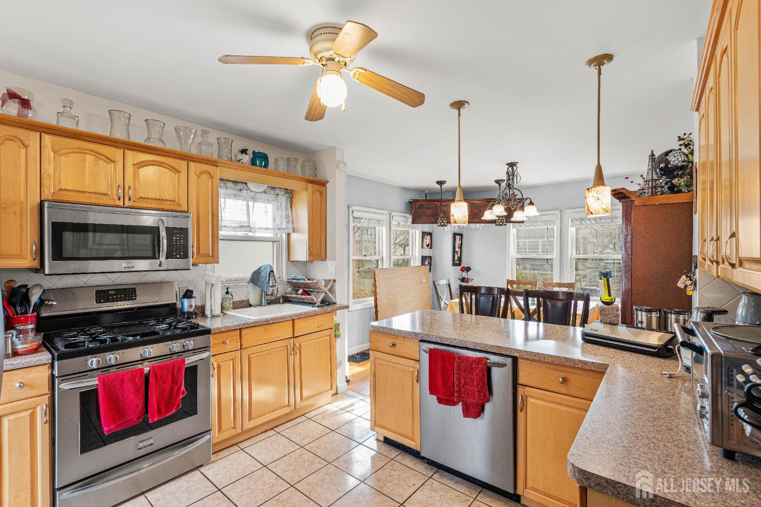 210 2nd Street Dunellen, NJ 08812 - Photo 15 of 42 a kitchen with stainless steel appliances kitchen island granite countertop a stove a sink and a microwave