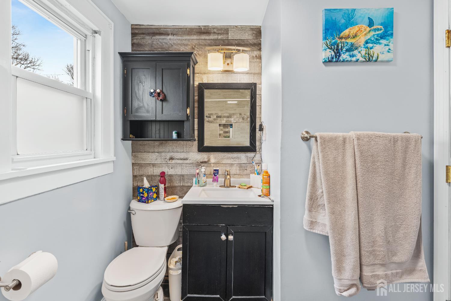 210 2nd Street Dunellen, NJ 08812 - Photo 21 of 42 a bathroom with a sink vanity mirror and toilet