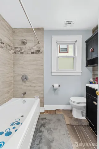 a bathroom with a bathtub and a toilet