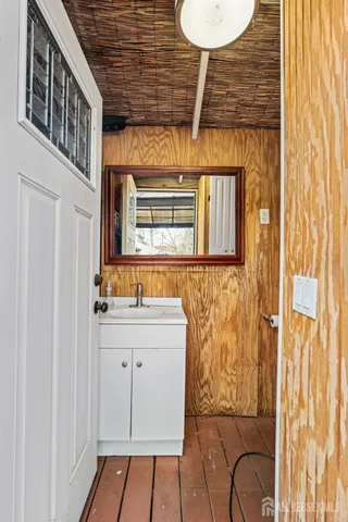 a bathroom with a sink a mirror and a shower