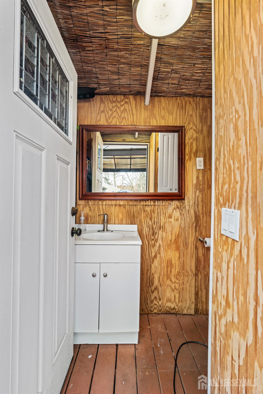 210 2nd Street Dunellen, NJ 08812 - Photo 28 of 42 a bathroom with a sink a mirror and a shower