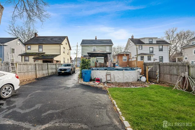 a view of a cars park in front of a house