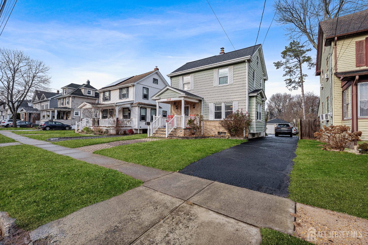 210 2nd Street Dunellen, NJ 08812 - Photo 35 of 42 a front view of a house with a yard table and chairs