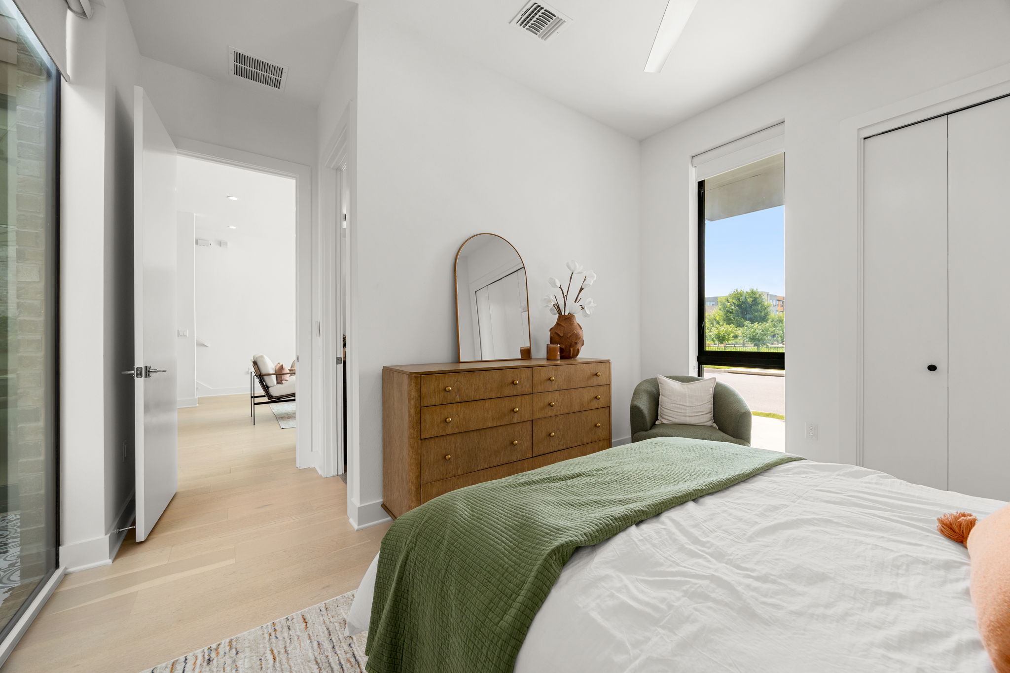 2524 Doc Reeves Street Austin, TX 78723 - Photo 13 of 36 Crisp white walls and warm wood flooring define this peaceful, sunlit bedroom retreat.