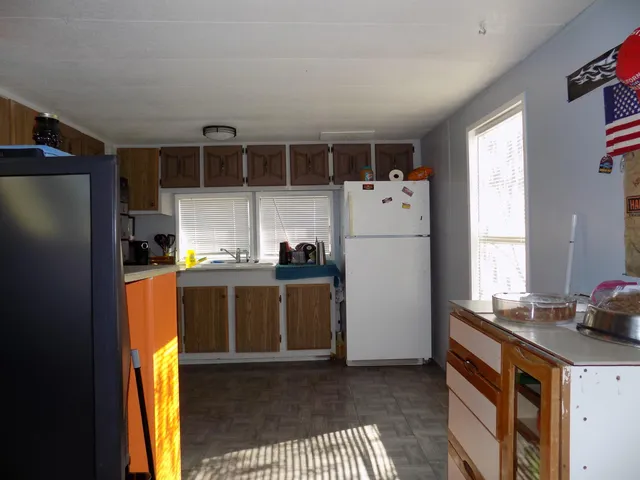 a kitchen with a refrigerator and a stove