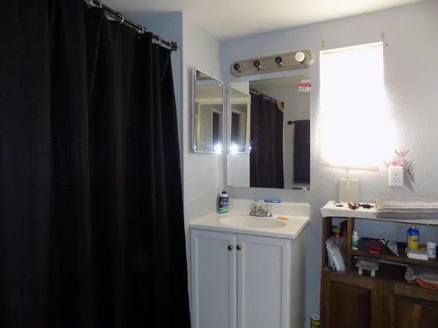 a bathroom with a sink and a mirror