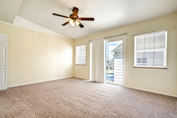 a view of a livingroom with a ceiling fan and window