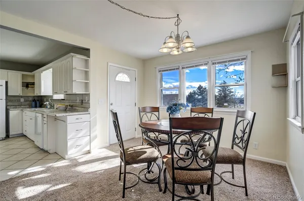 a view of a dining room with furniture wooden floor and chandelier