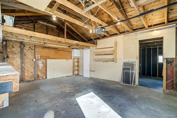 a view of a room with washing machine and racks