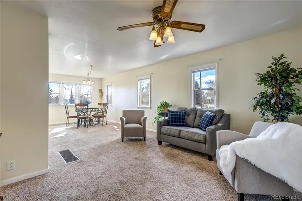 a living room with furniture and a chandelier