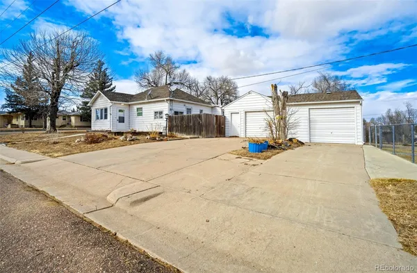 a dining room with furniture a wooden table and chandelier