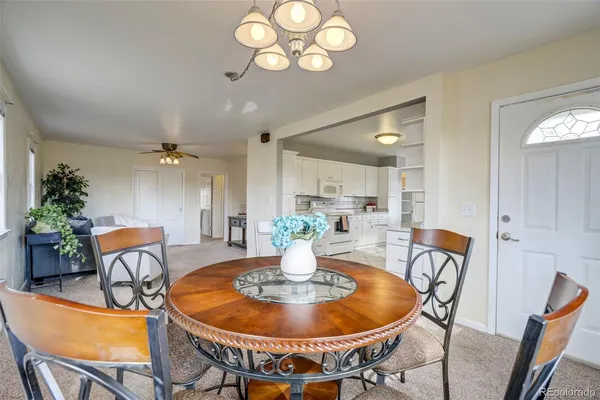 a view of a dining room with furniture and chandelier