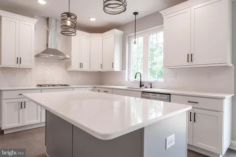 a kitchen with a sink a window and cabinets