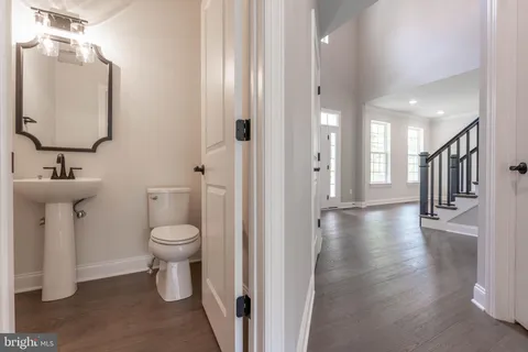 a bathroom with a sink toilet and a mirror