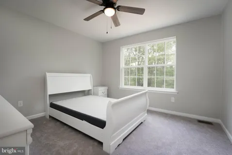 a bed room with a bed and window