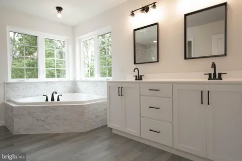 a bath tub sitting next to a bathroom sink