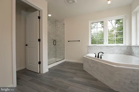 a spacious bathroom with a bathtub and shower