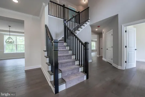 a view of a hallway with wooden floor and entryway
