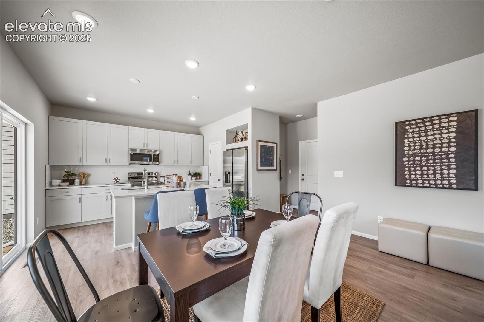 4866 Truscott Road Colorado Springs, CO 80925 - Photo 6 of 20 Open-concept living area featuring wood-finish flooring and recessed lighting
*Photos of a model home*