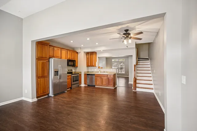 a view of a kitchen with furniture and wooden floor