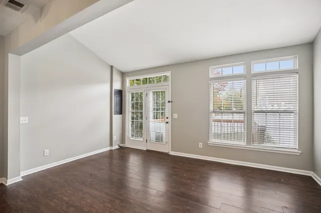 a view of an empty room with wooden floor