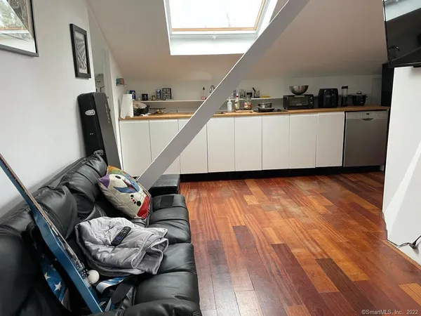 a view of a workspace with furniture and a window