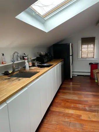 a living room with a couch piano and a table