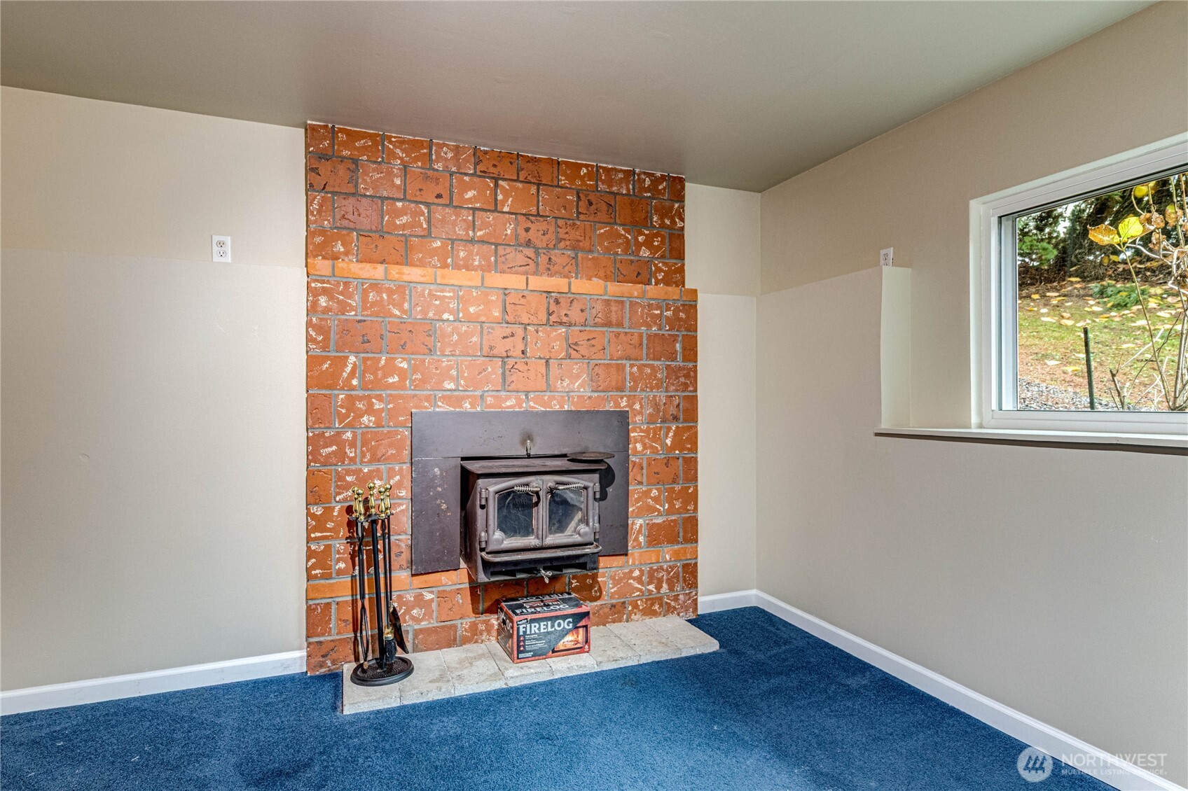 321 216th Street Southeast Bothell, WA 98021 - Photo 22 of 33 a living room with a fireplace and a window
