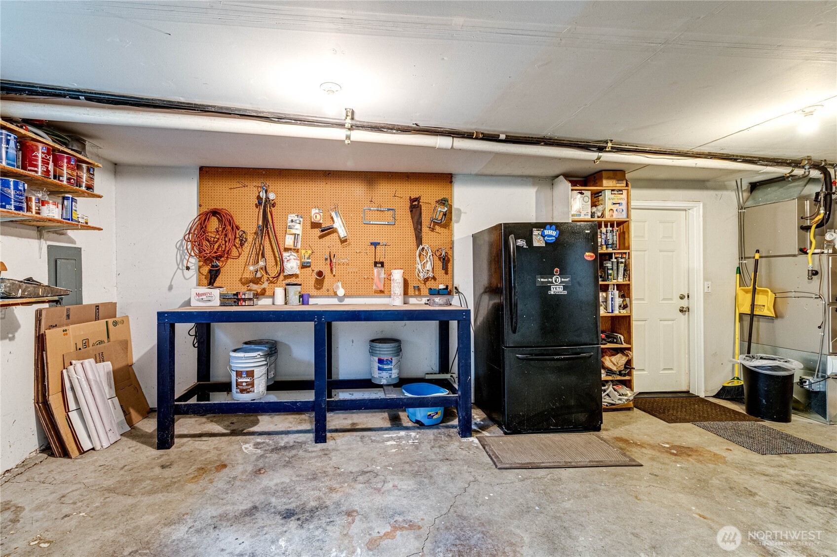 321 216th Street Southeast Bothell, WA 98021 - Photo 25 of 33 a living room with furniture a flat screen tv and a refrigerator
