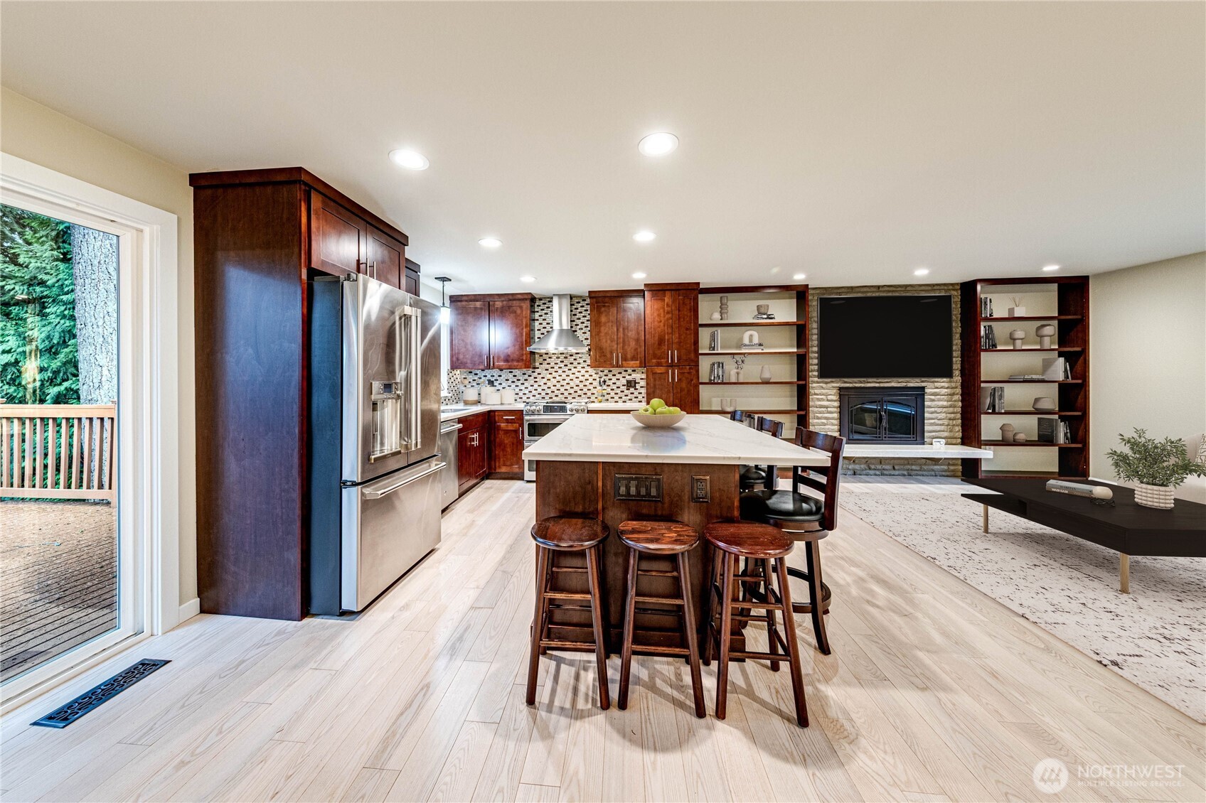 321 216th Street Southeast Bothell, WA 98021 - Photo 6 of 33 a kitchen with stainless steel appliances kitchen island granite countertop a table chairs refrigerator and sink