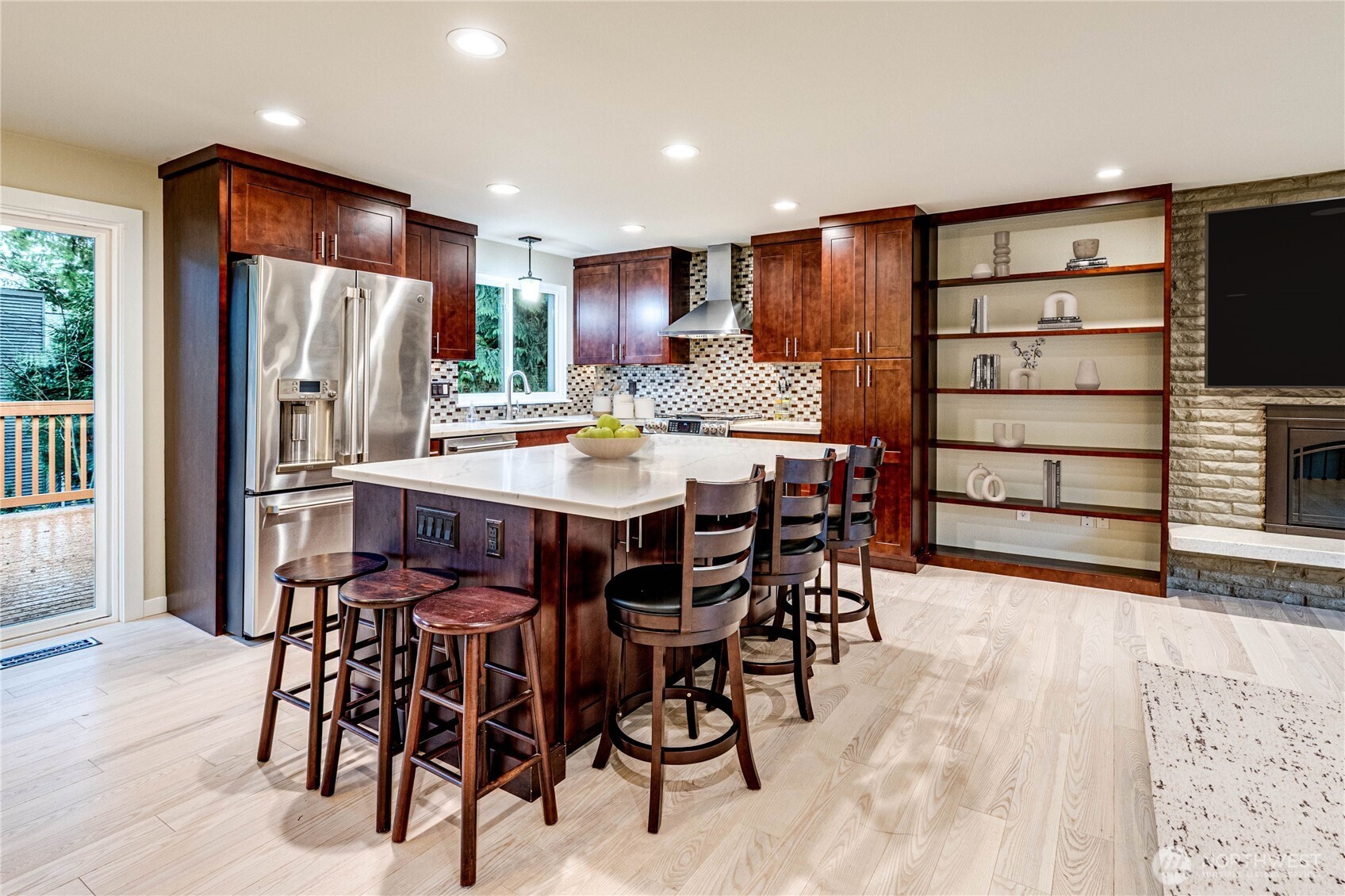 321 216th Street Southeast Bothell, WA 98021 - Photo 7 of 33 a kitchen with stainless steel appliances granite countertop a table chairs refrigerator and a sink