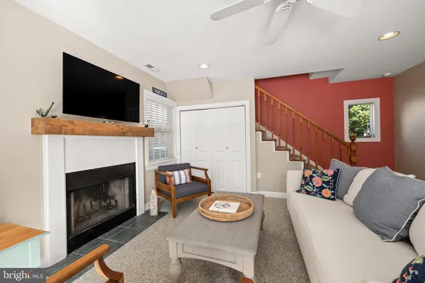 a living room with furniture a flat screen tv and a fireplace