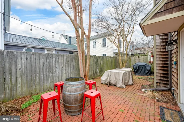 a front view of a house with outdoor seating